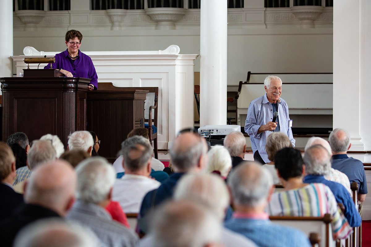 President Biddy Martin at the podium, speaking with alumni during Reunion 2019