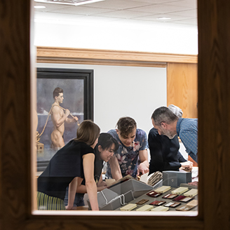 People looking at display cases in the Amherst library