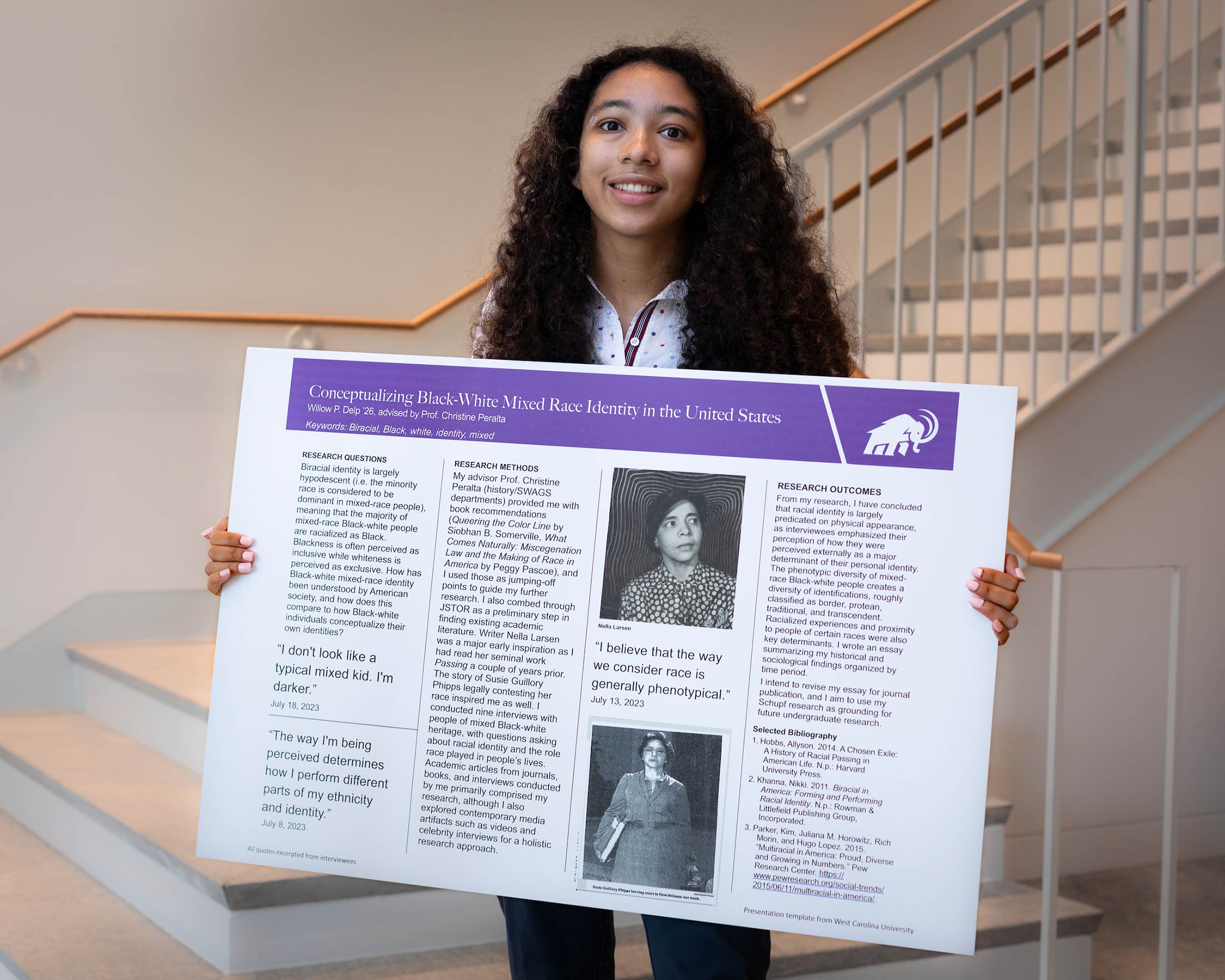 Willow Delp holds her research poster titled Conceptualizing Black-White Mixed Race Identity in the United States.
