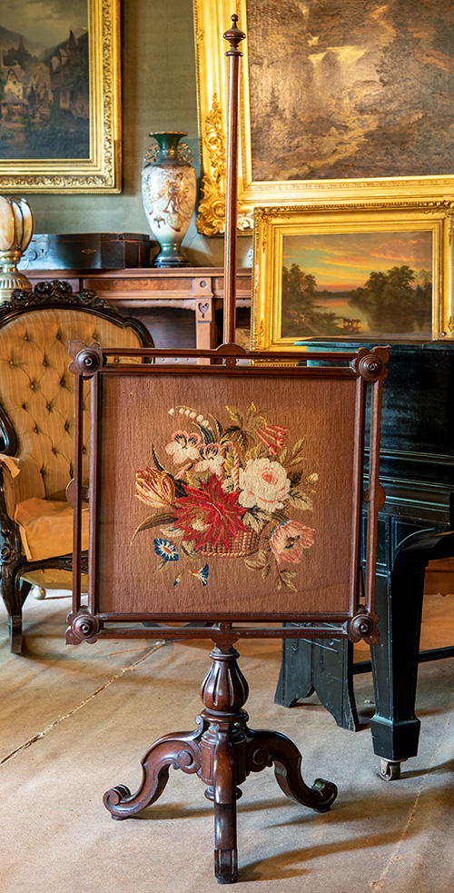 A needlepoint fabric displayed on a wooden easel