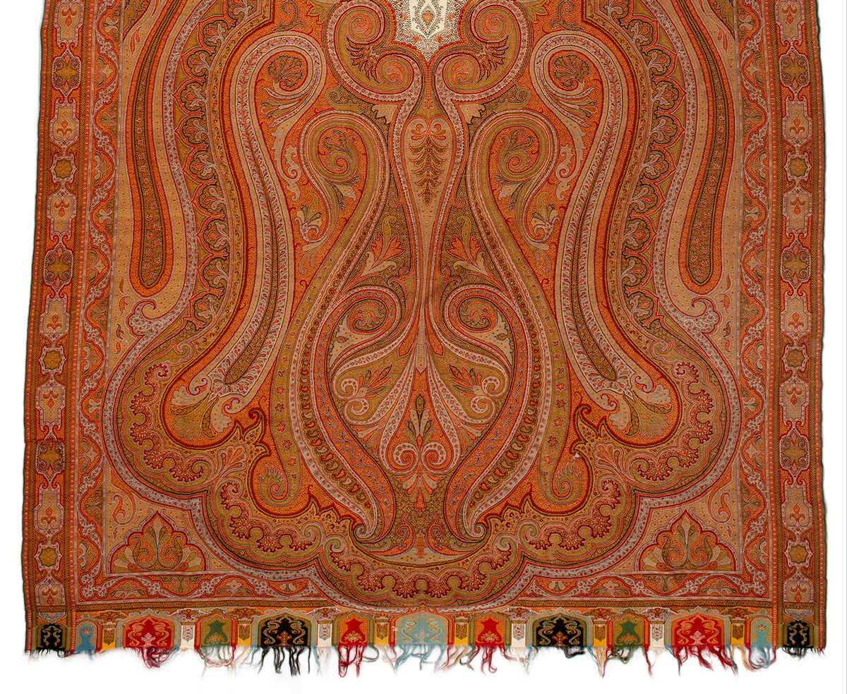 An intricate shawl with a Persian pattern in shades of orange