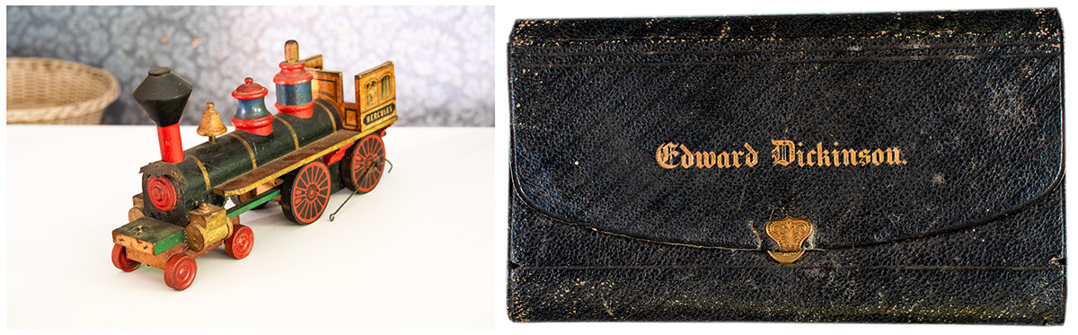 An antique toy train and an old black leather wallet