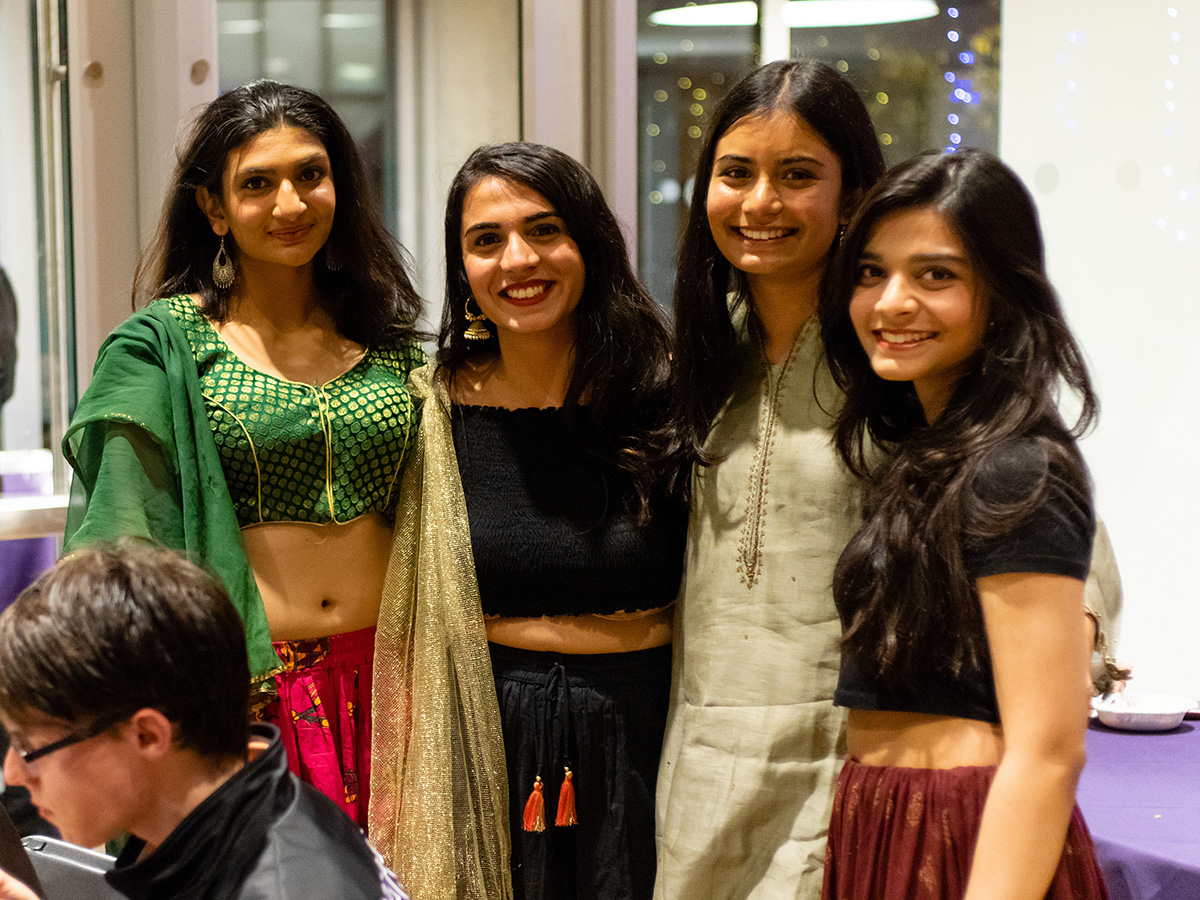 Four women dressed in Indian clothing at a party