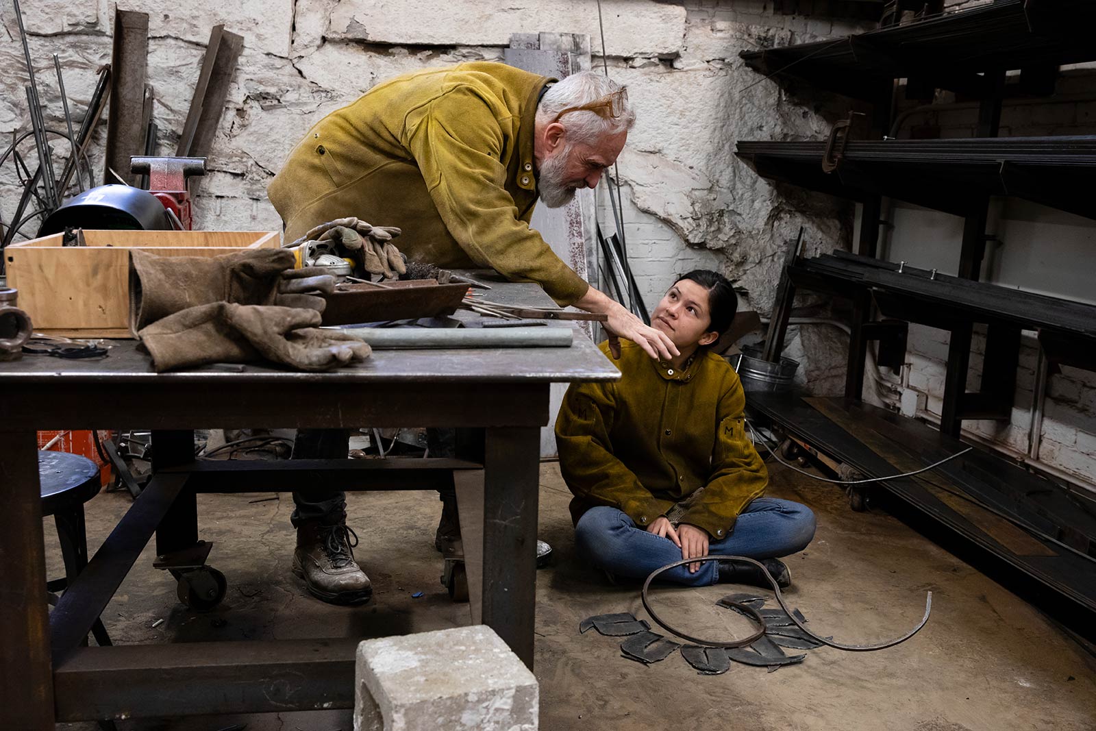 Professor Culhane instructs a student in his sculpture class