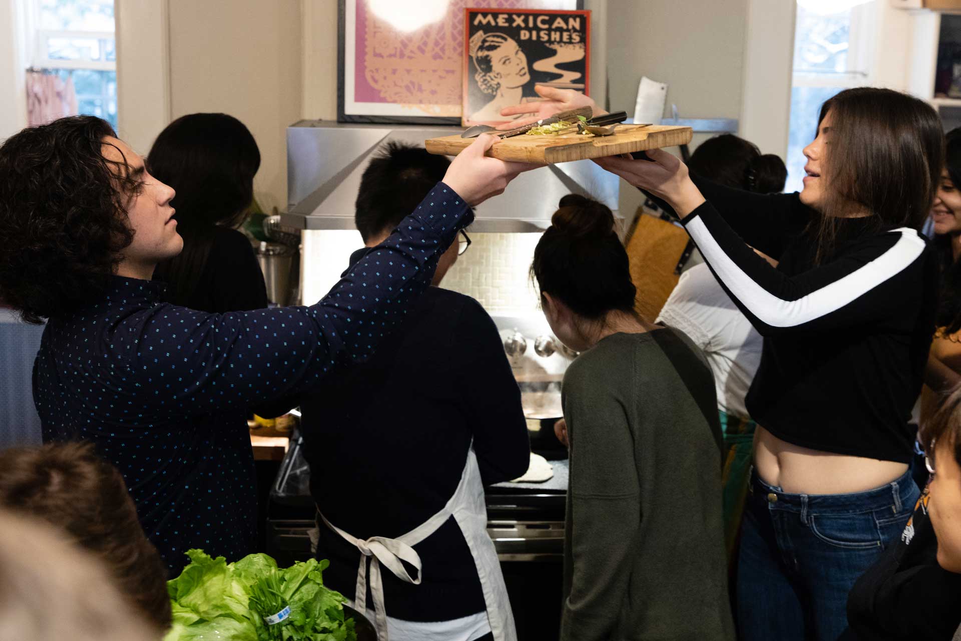 A group of student preparing food together in a kitchen