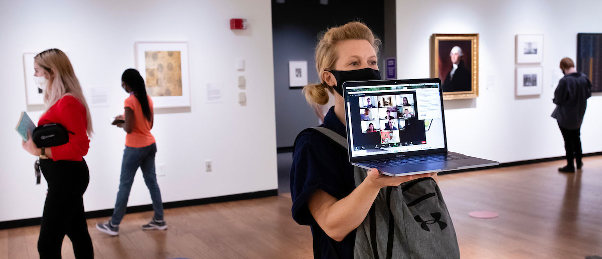 a professor wholes up a laptop for remote students to see inside the mead art museum