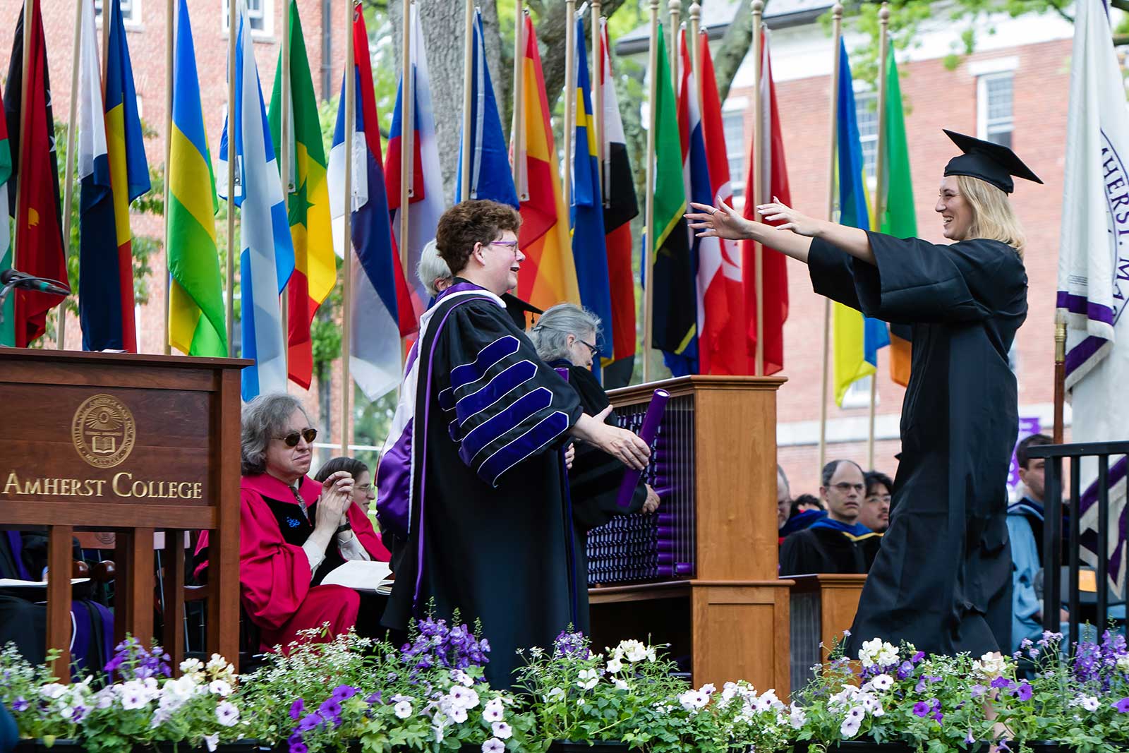 President Martin embracing a new graduate