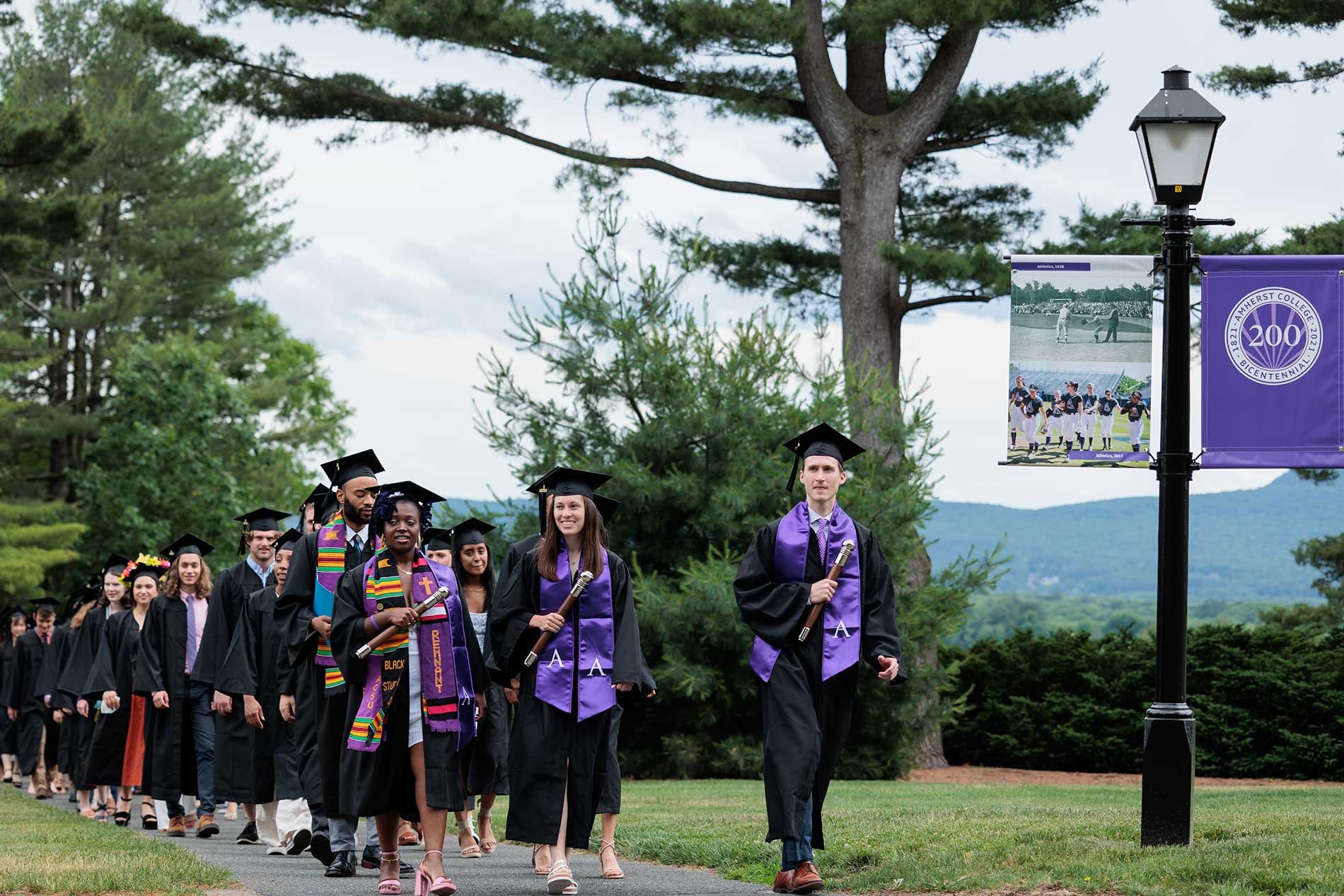 Graduates processing across the academic quad at Amherst College.