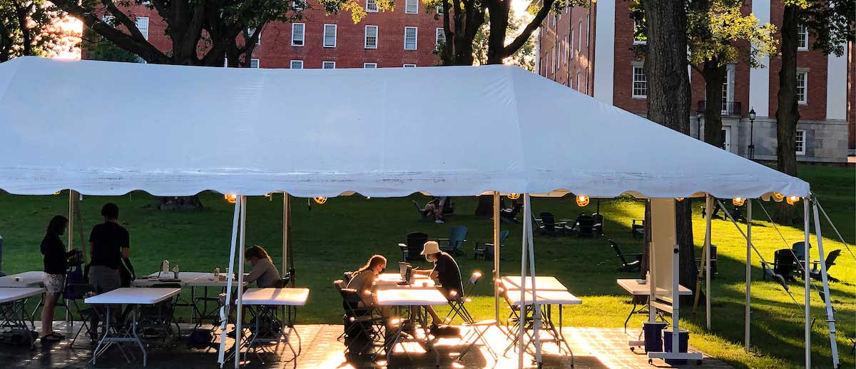 students studying under a tent on the amherst college campus
