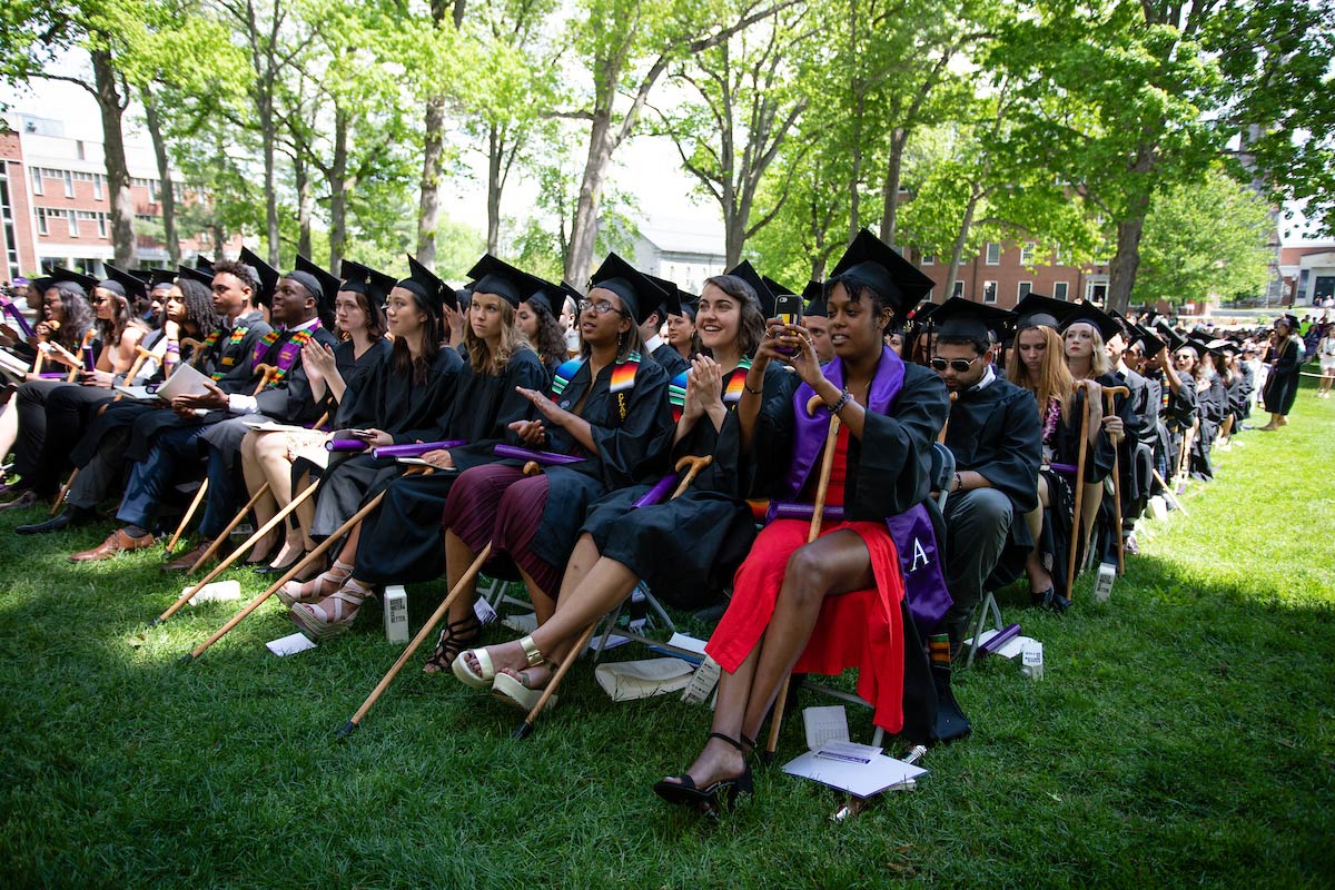 Amherst graduates sitting with their traditional canes