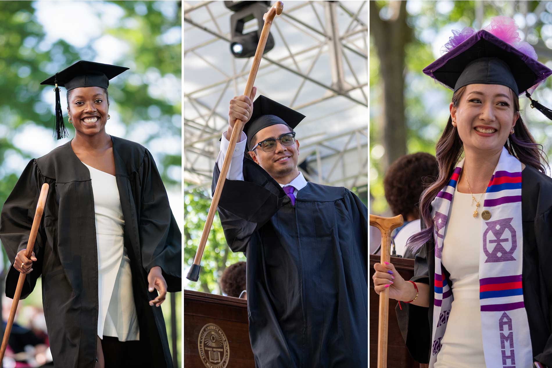 Three students celebrate receiving their diplomas.