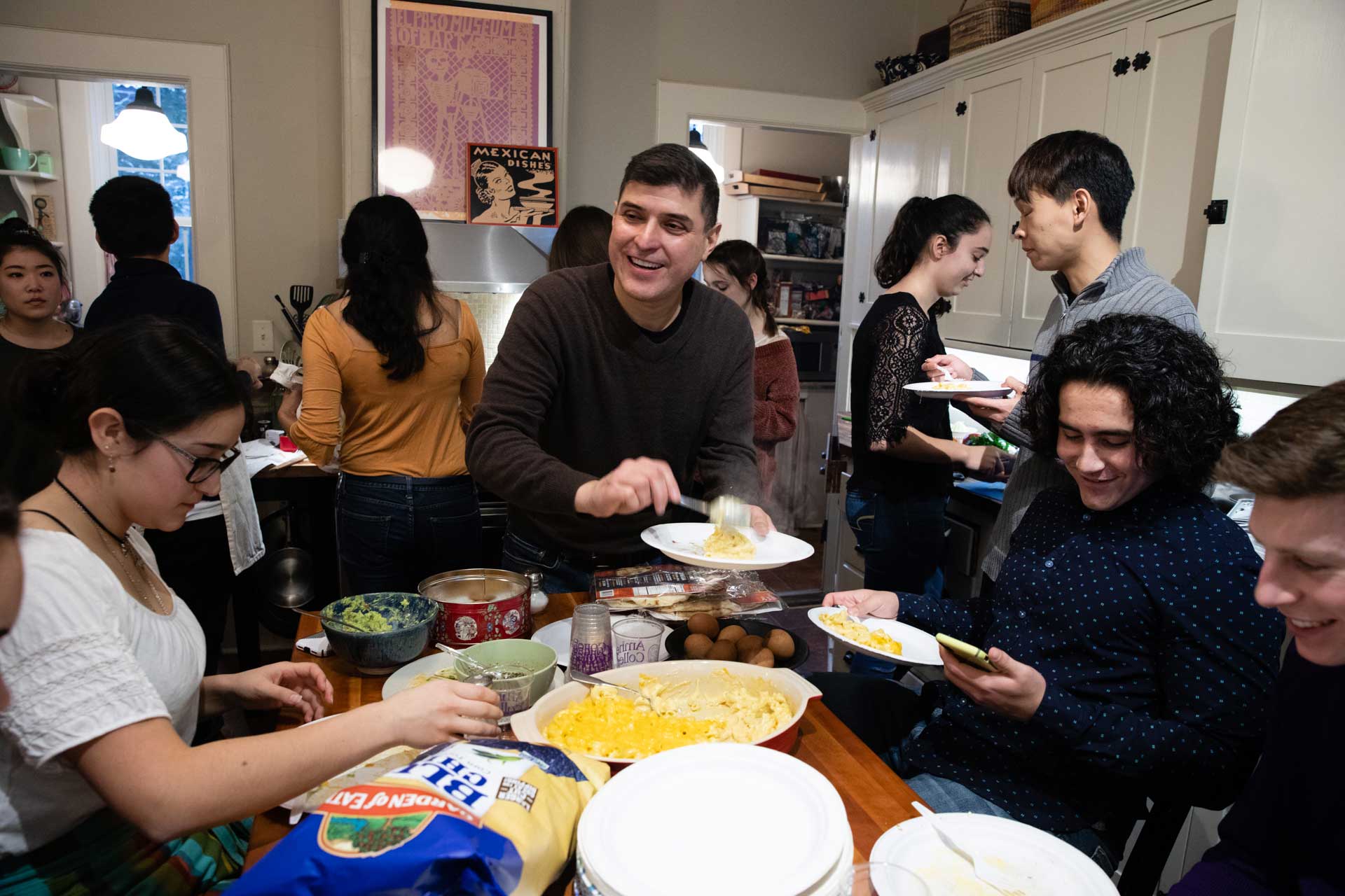 College students eating together in a kitchen