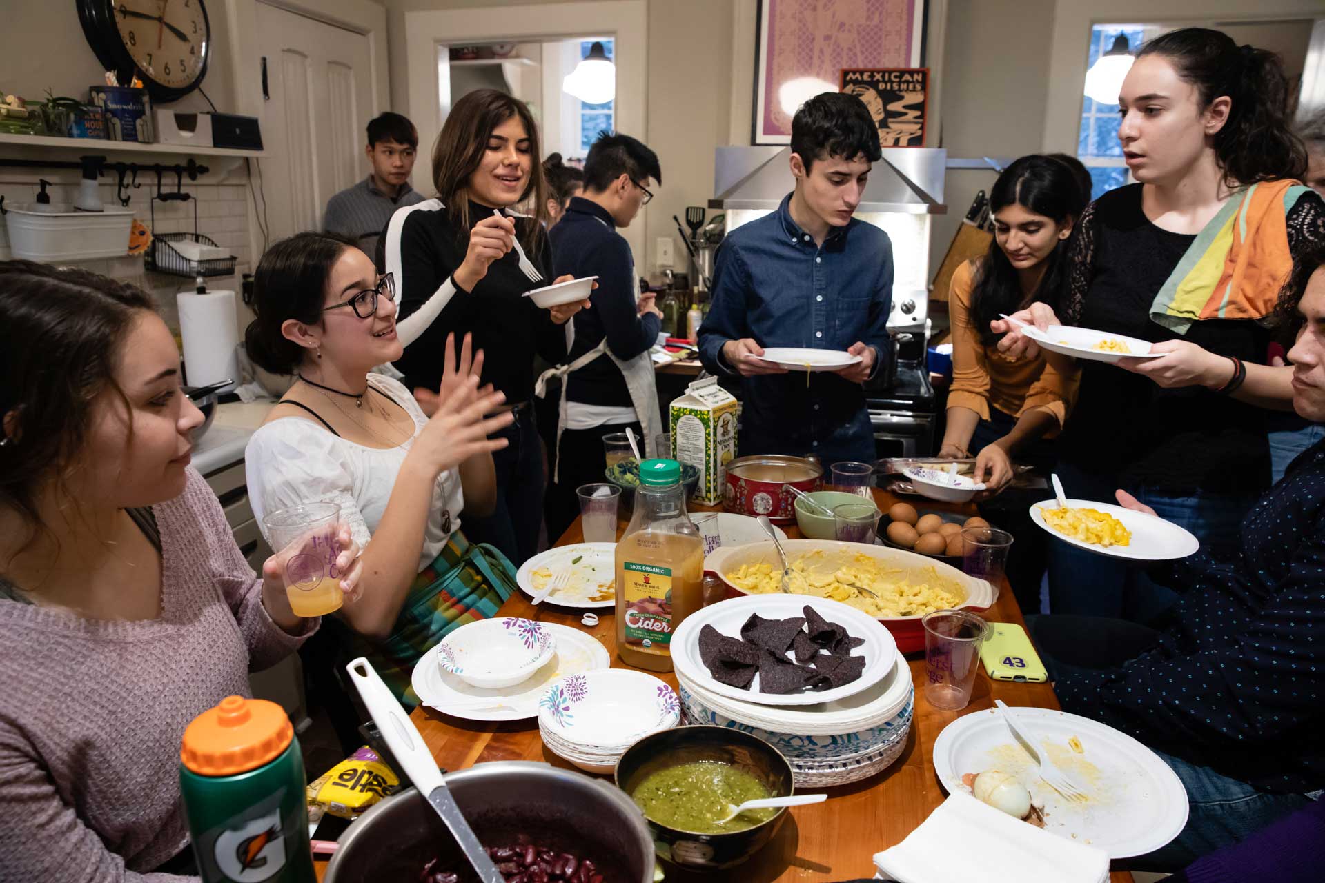 College students eating together in a kitchen