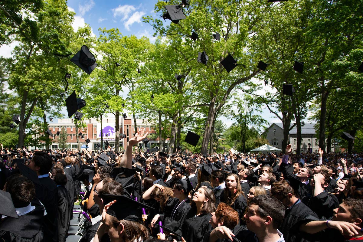 Students toss their caps at the end of the ceremony