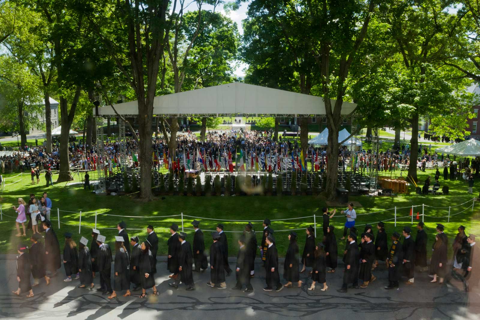 graduating students arrive in procession on the quad