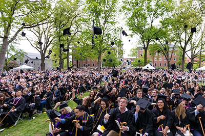 Student toss their graduation caps at Commencement at Amherst College