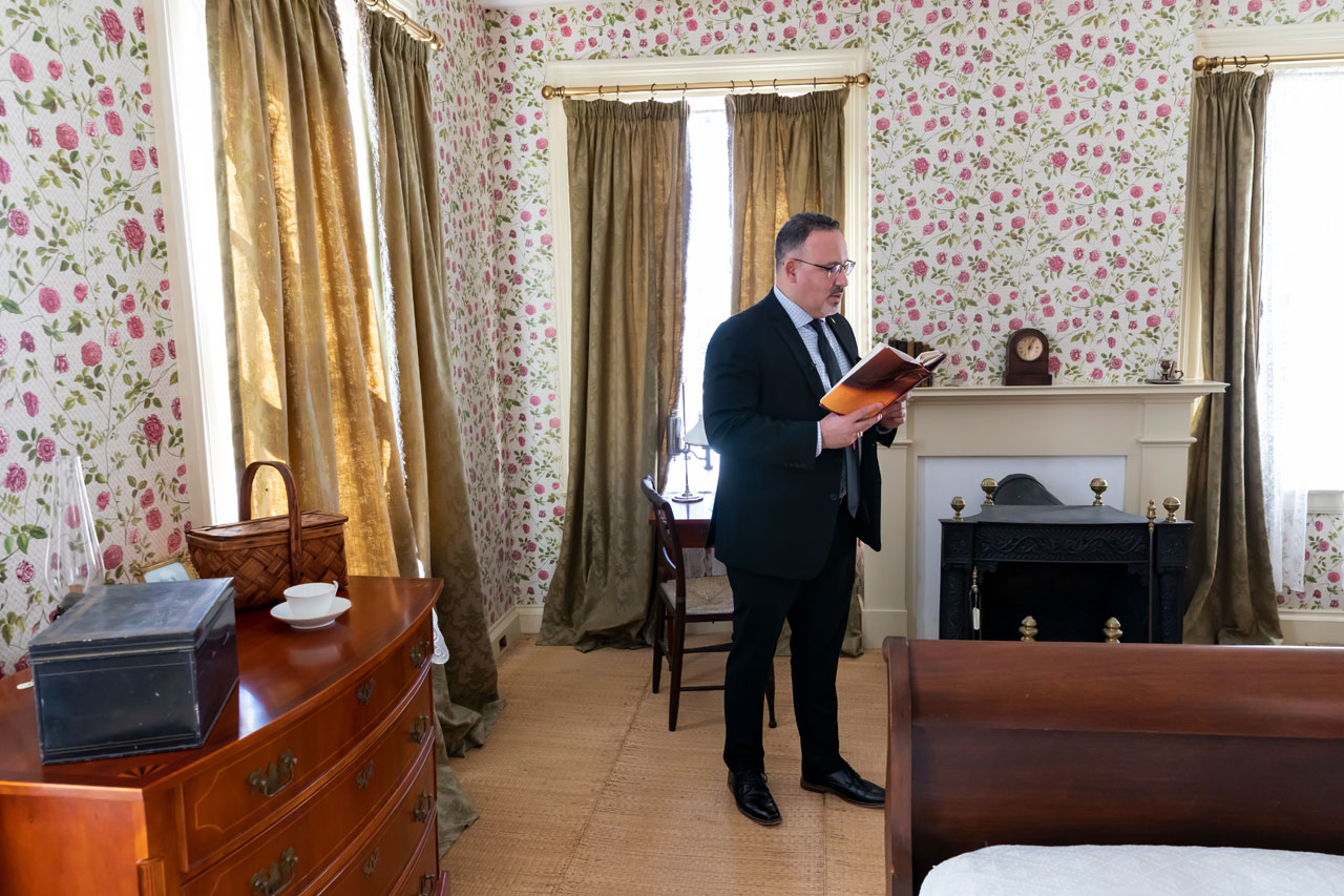 Miguel Cardona reads a poem in Emily Dickinson's bedroom