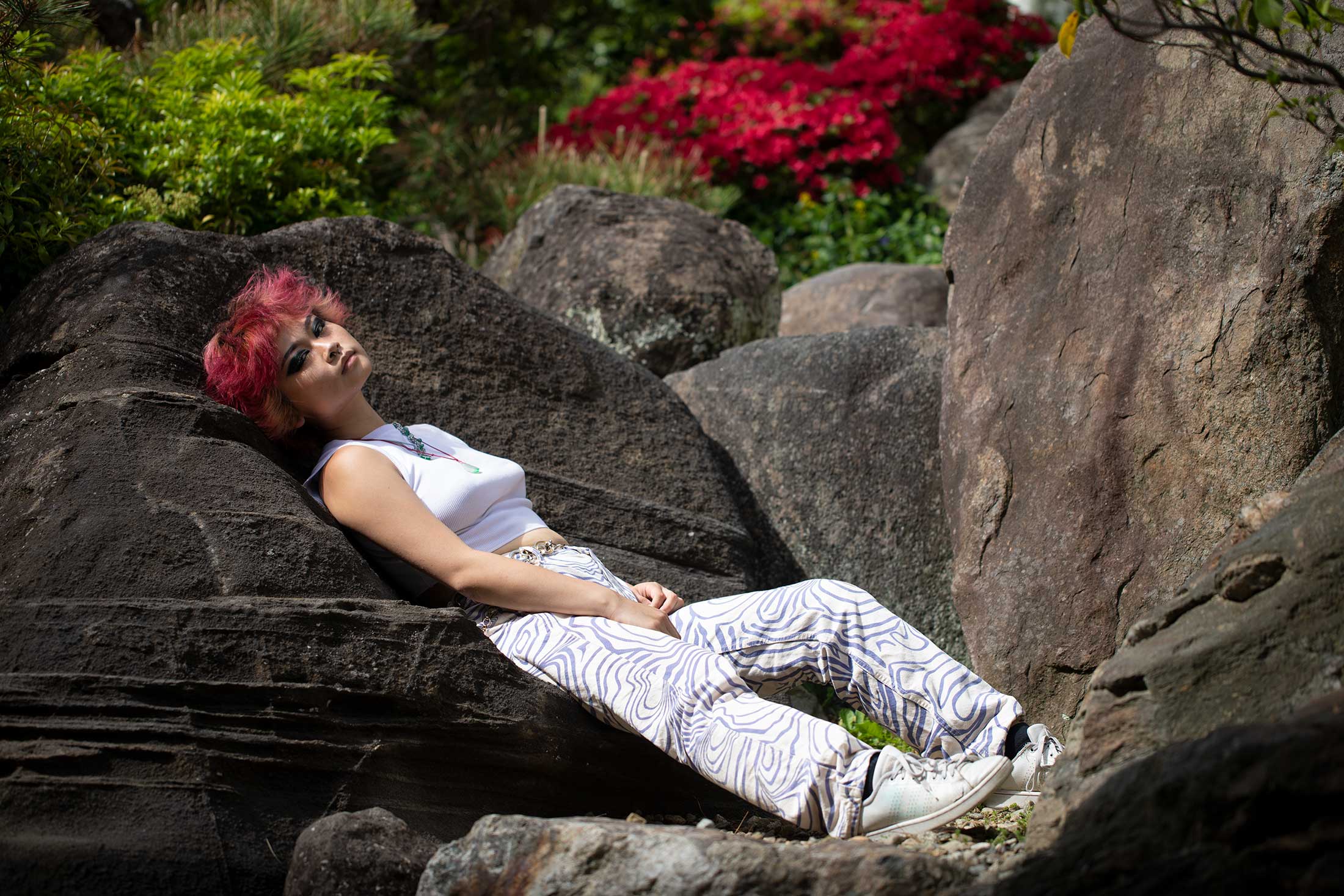 Hibiscus Zhang reclines in the Yushien Japanese Garden on the Amherst College campus.