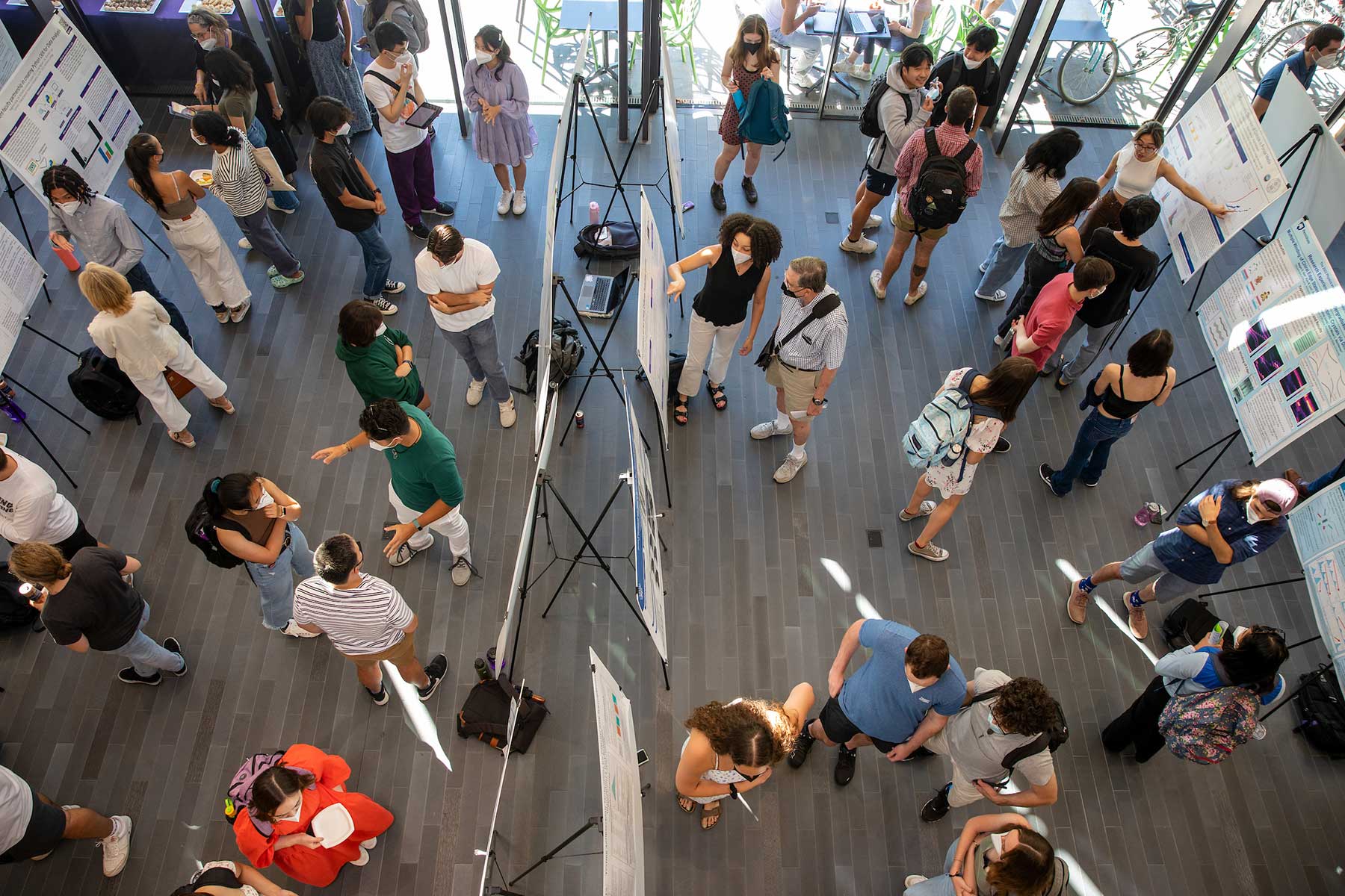 An aerial view of people visiting a poster session in the Science Center.