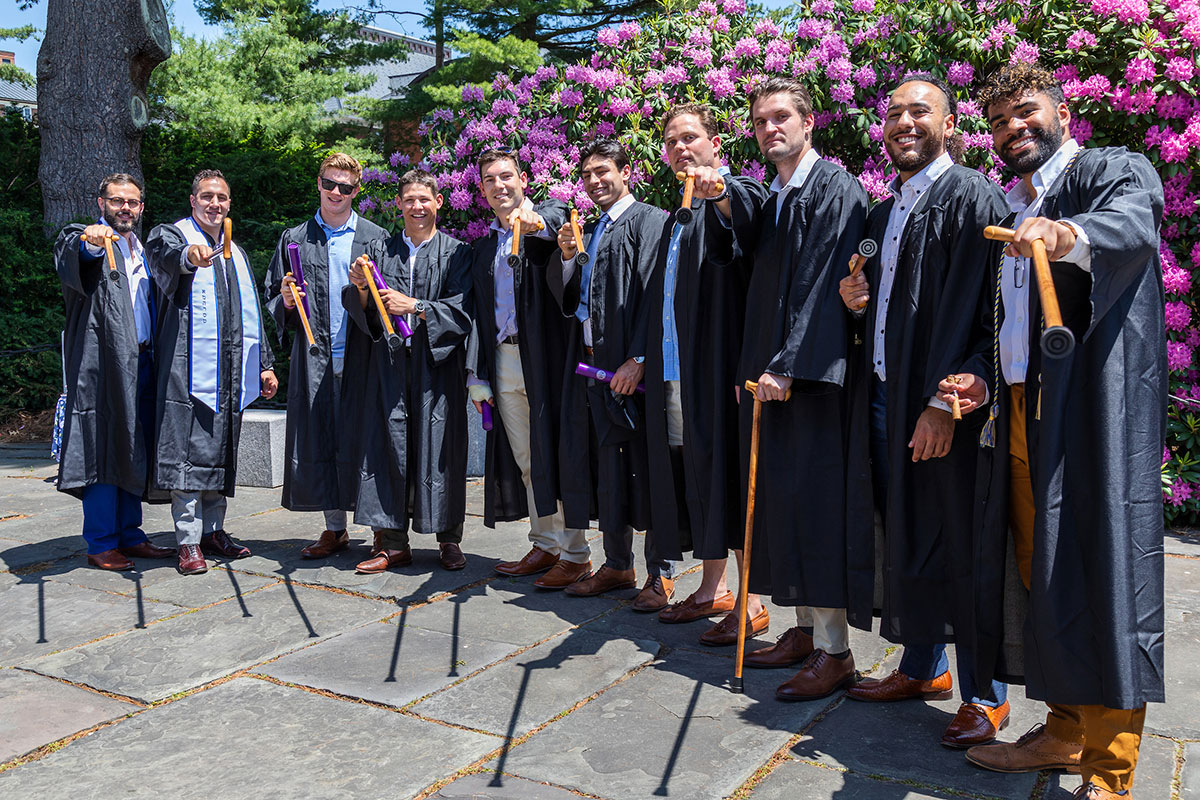 A line of graduates pose with their Conway Canes.