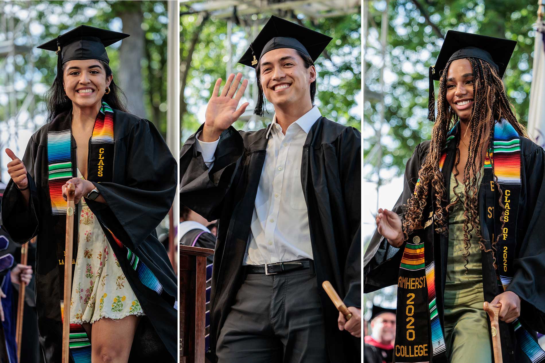 Three students celebrating receiving their diplomas.