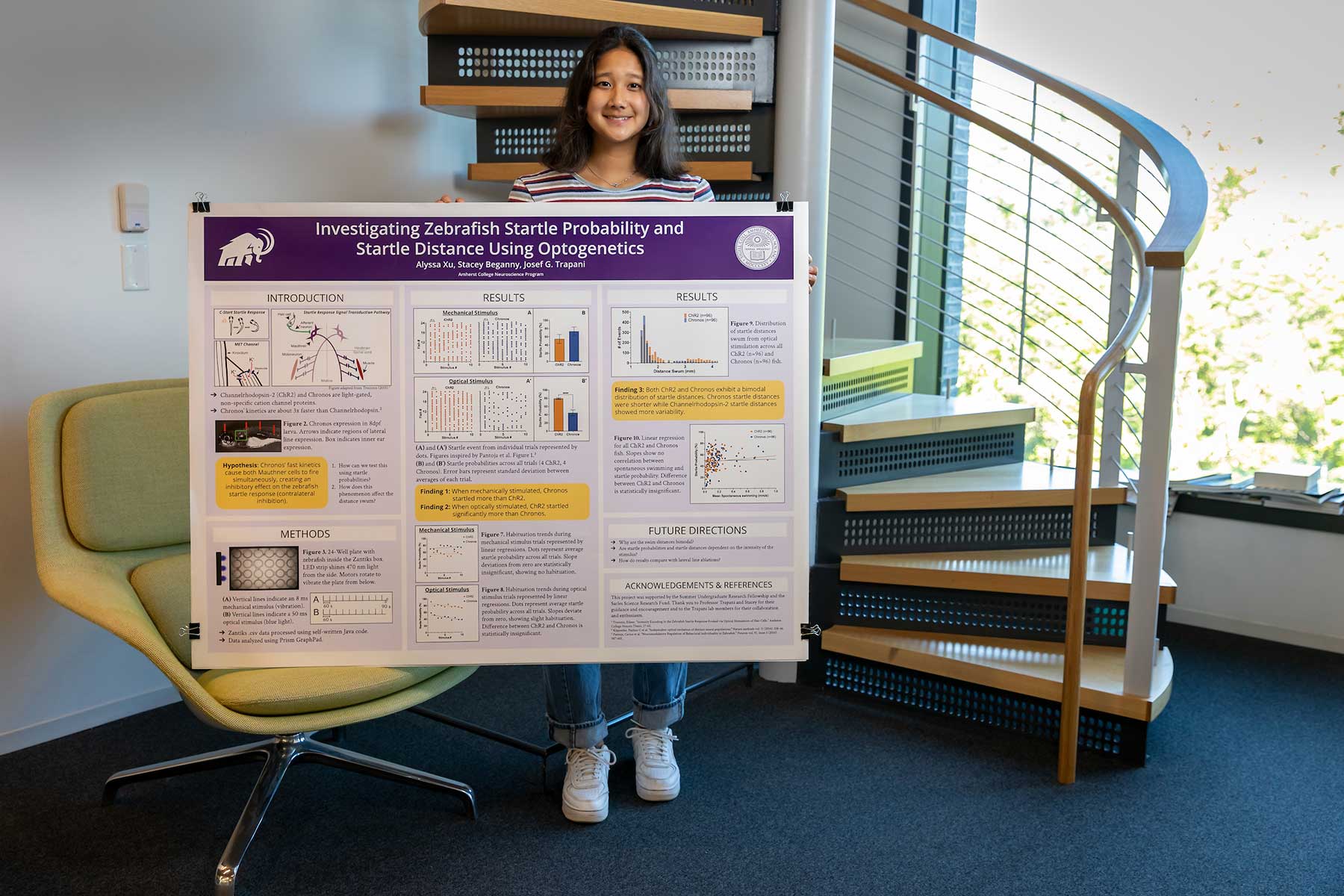 Alyssa Xu '25 holds a poster on her summer research on Zebrafish.