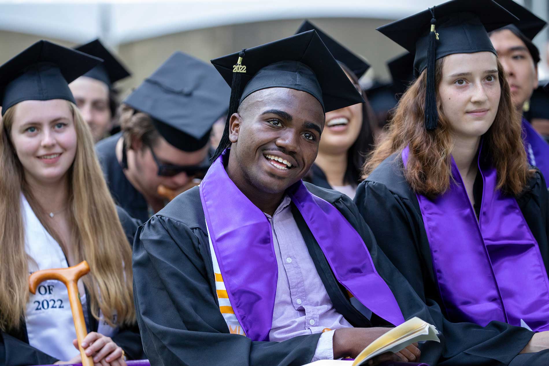 Abdullah Brownel ’22, the student commencement speaker, smiles while sitting with his classmates.