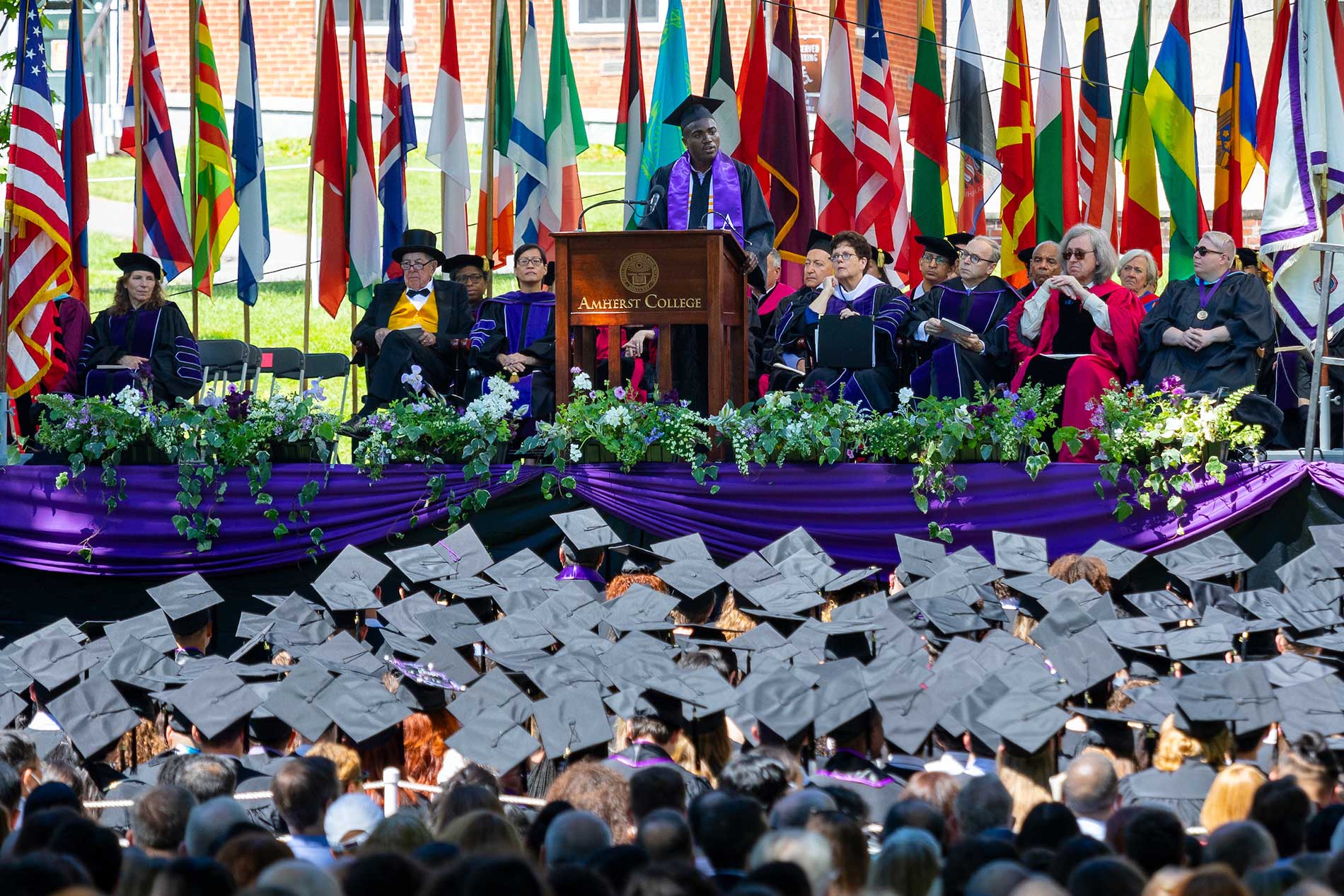 A view of the stage during commencement where faculty and administrators look out at the crowd of graduating seniors.