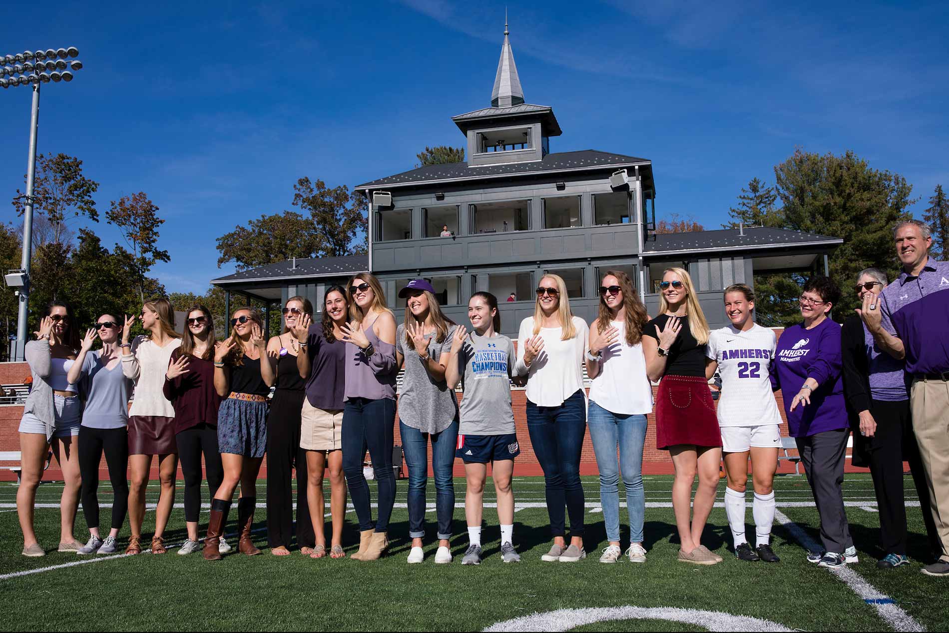 Biddy Martin poses with the women's soccer team during the 2017 homecoming football game.