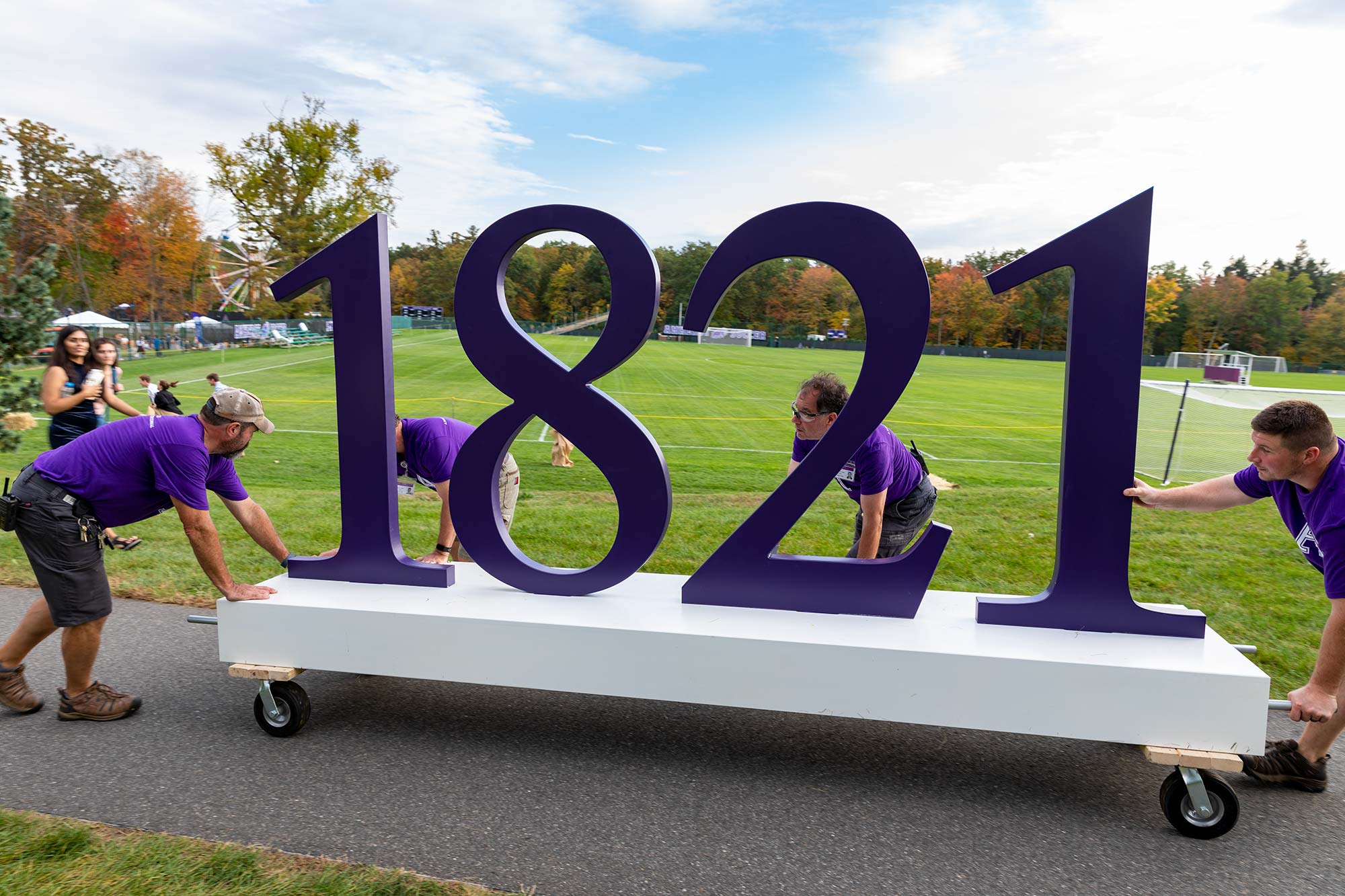 Amherst College staff moving the 1821 sculpture across campus for the bicentennial party