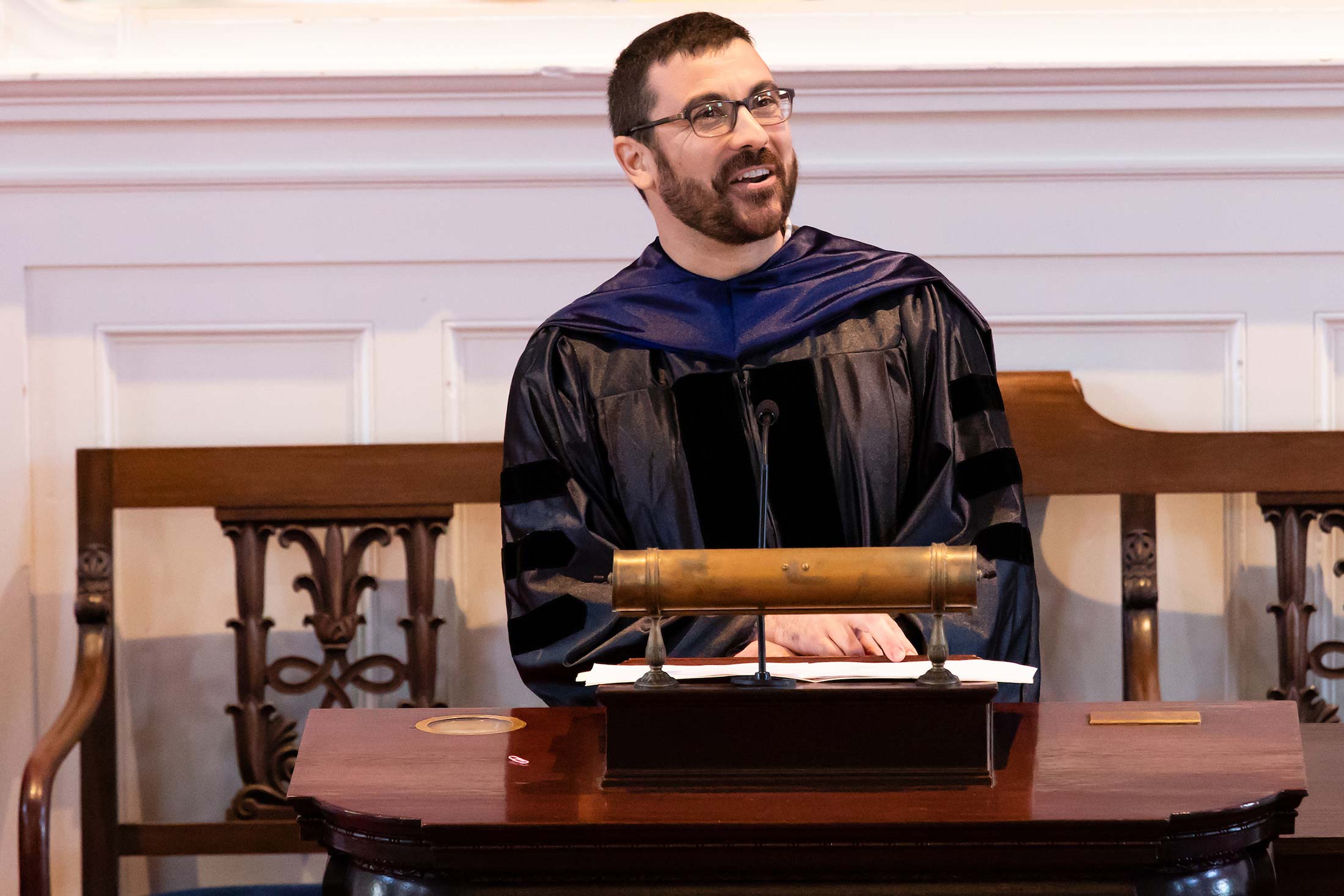 Professor Josef Trapani speaking to students during Senior Awards Assembly in Johnson Chapel at Amherst College