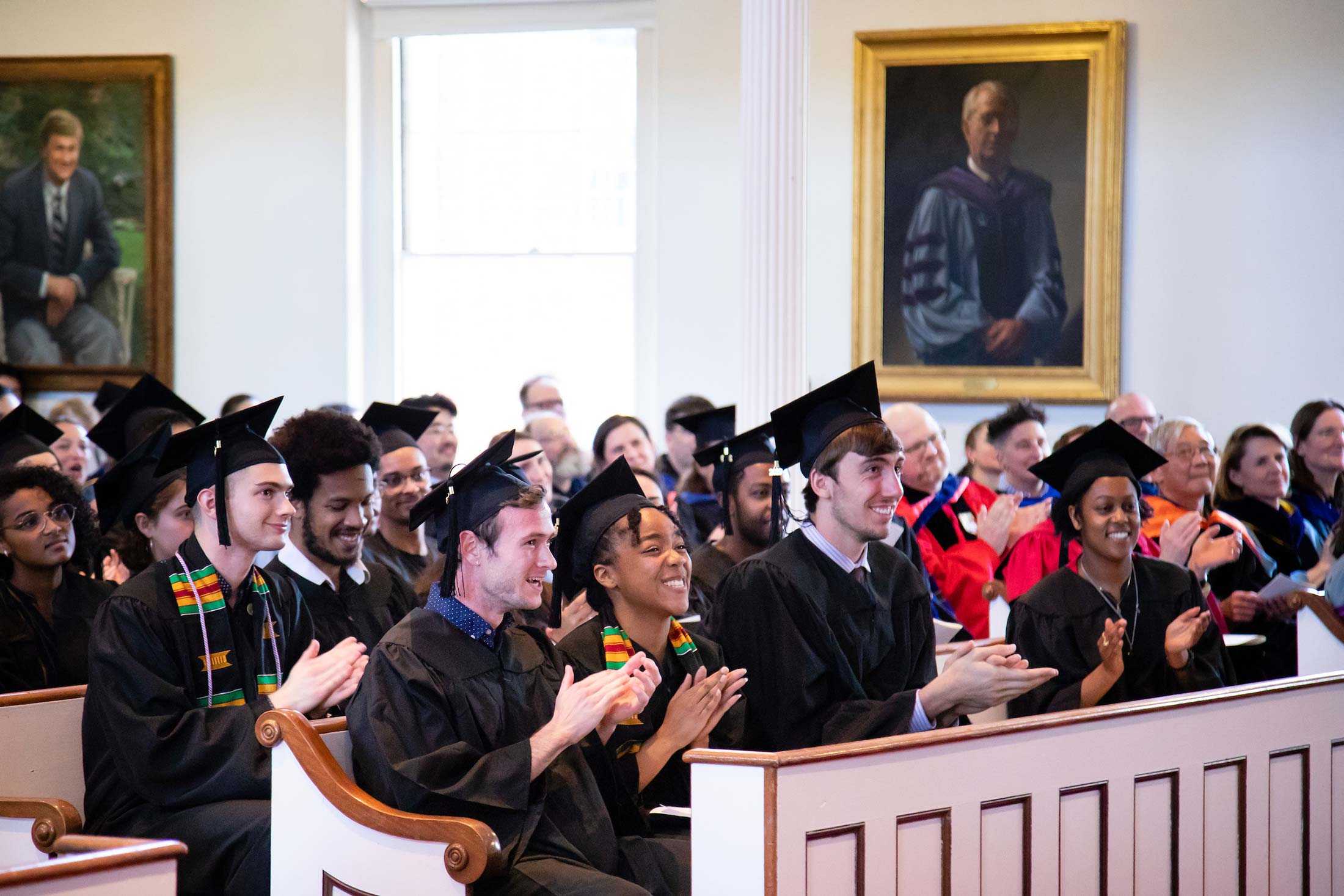Students listening to speeches during Senior Awards Assembly in Johnson Chapel at Amherst College