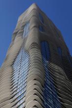 September 8, 2009<br><b>The Aqua tower in Chicago</b><br>Aqua, the spectacular new Chicago skyscraper with the sensuous, undulating balconies, is the pearl of the long-running, now-ending Chicago building boom, a design that is as fresh conceptually as it is visually. A skyscraper typically consists of repetitive, right-angled parts, a money-saving device that frequently produces aesthetic monotony. But in this defiantly non-Euclidian high-rise, almost nothing seems to repeat. Its white, wafer-thin balconies bulge outward, each slightly different from the other. They race around corners and shoot upward in fantastic, voluptuous stacks. This is a new vision of verticality, and it makes Aqua one of Chicago's boldest -- and best -- skyscrapers in years.<br><i>Chicago Tribune photo by Michael Tercha</i>