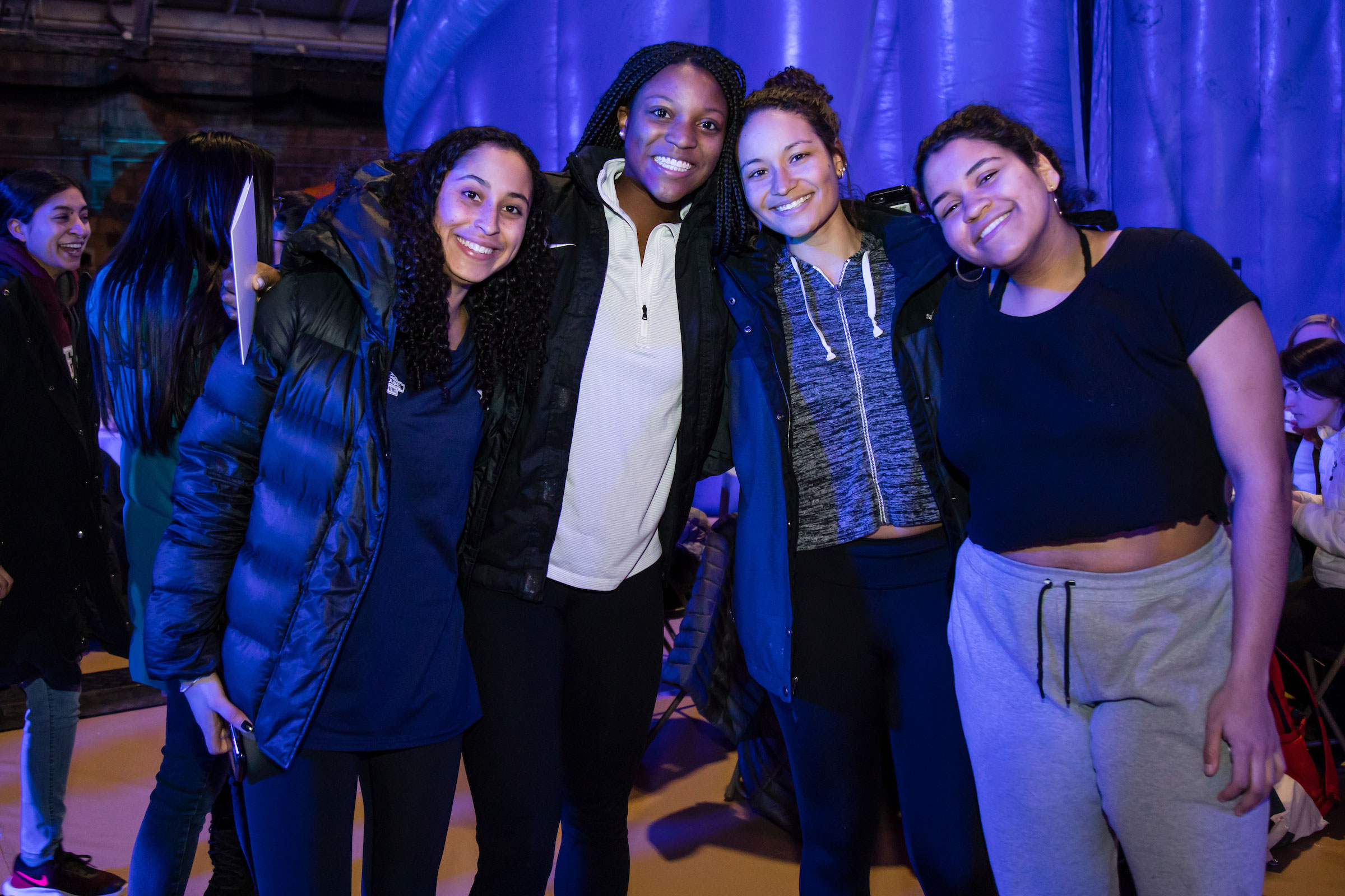 Four smiling women pose for the camera at Winter Fest