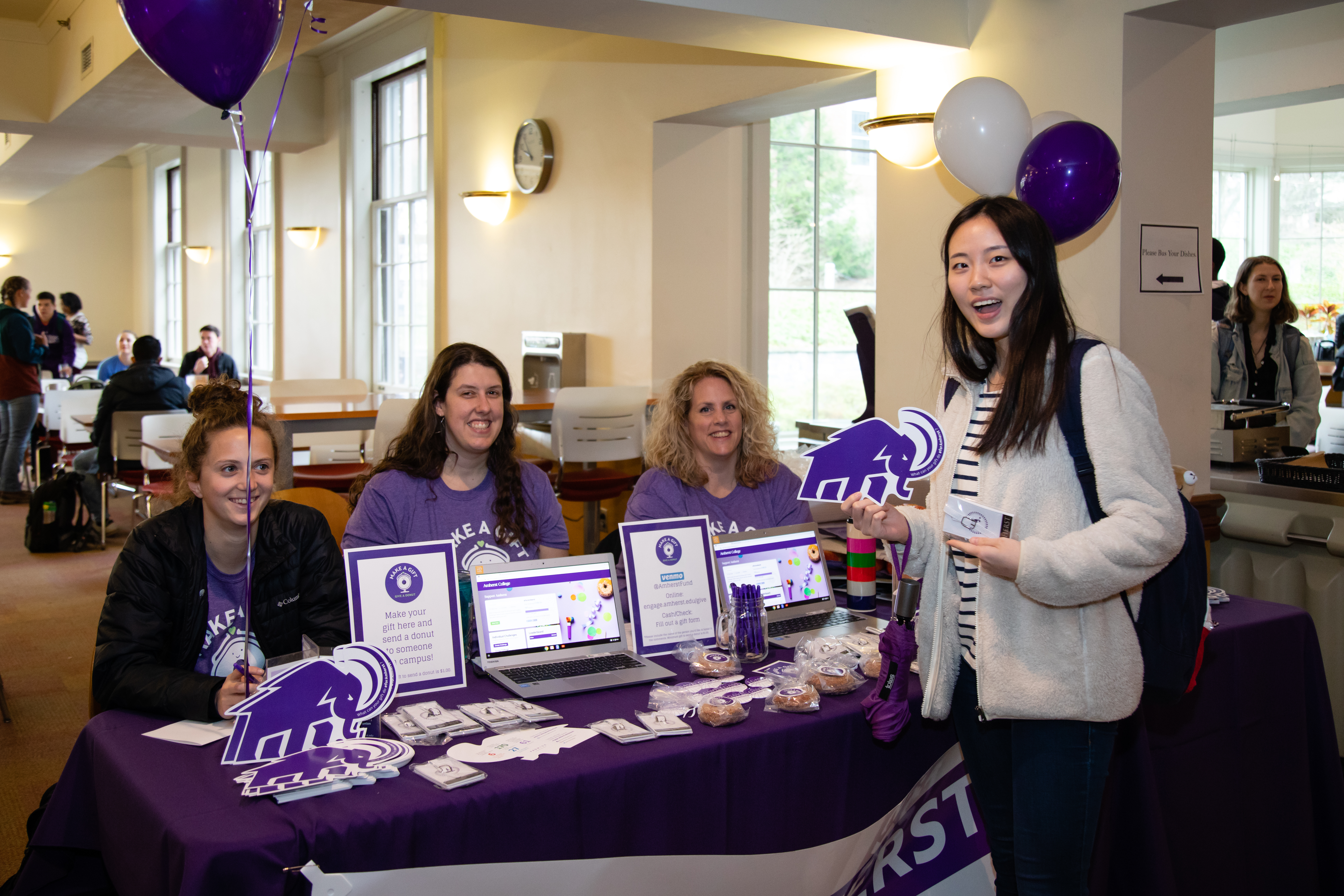 Students and staff at a giving day table in Valentine Dining Hall