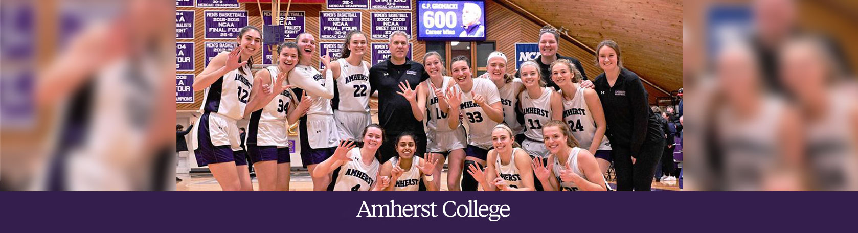 Coach G.P. Gromacki and the Amherst College women's basketball team celebrate a win.