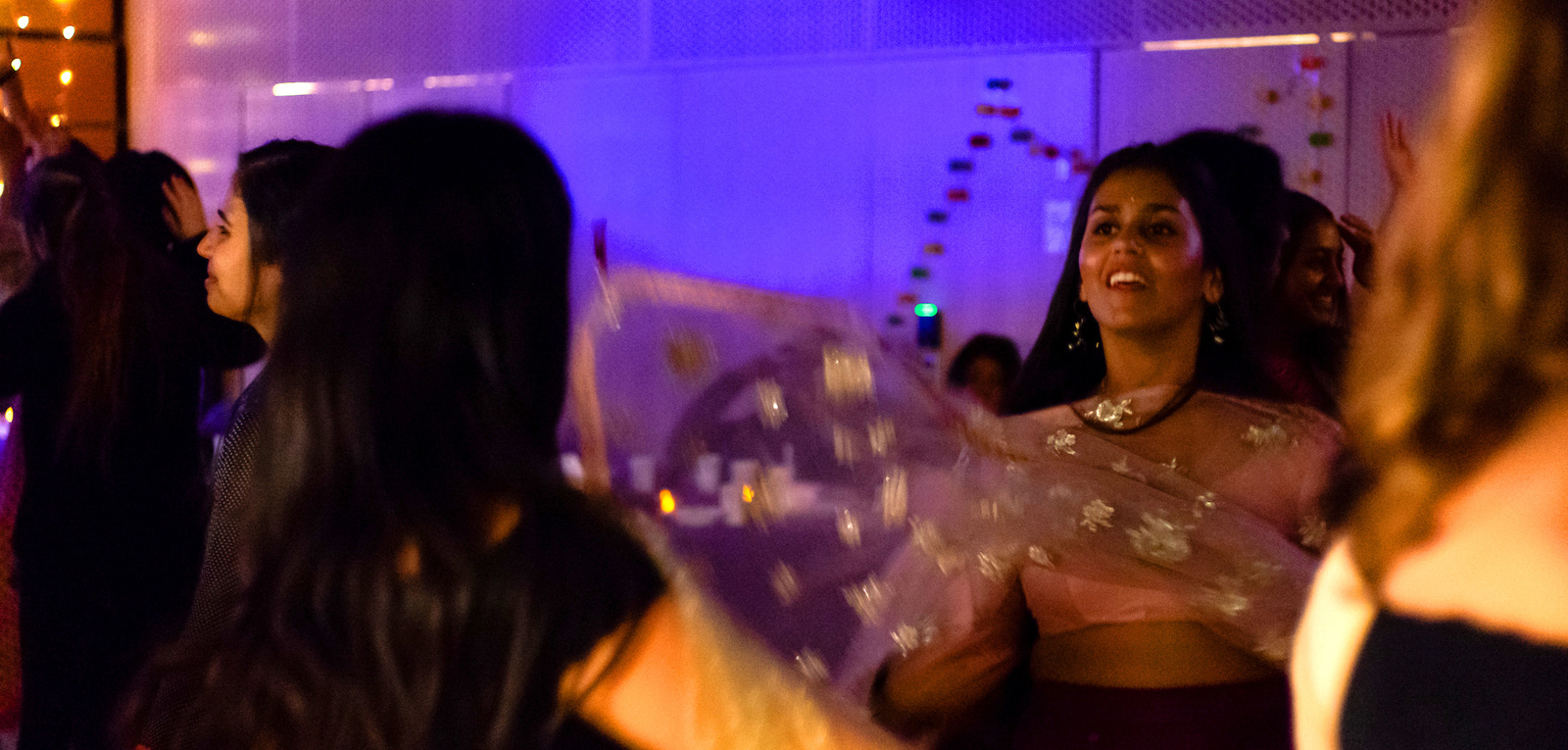 student wearing traditional Indian attire dances at a Diwali festival at Amherst
