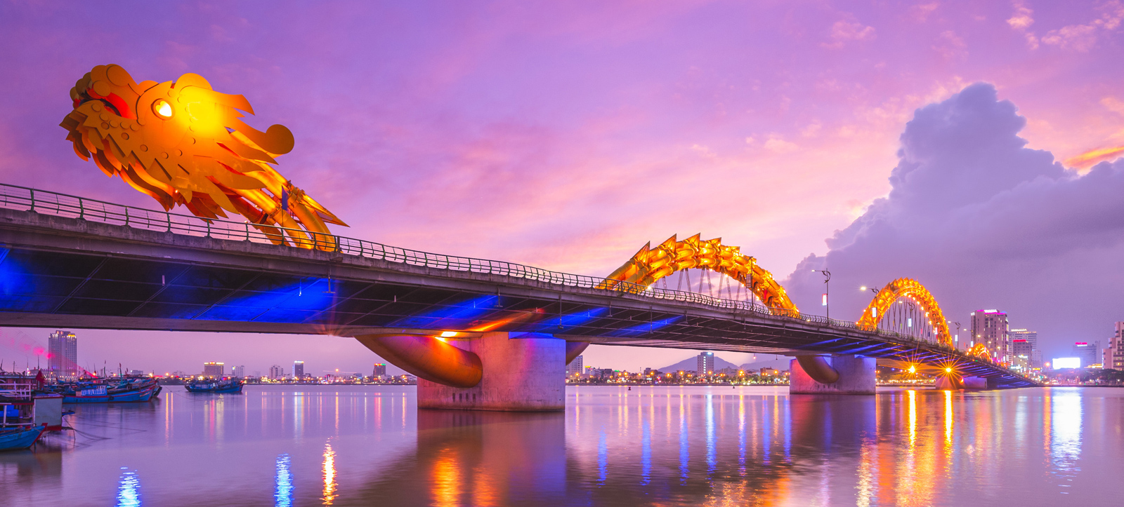 Dragon bridge in Vietnam, a colorful, fiery dragon undulates along a bridge with a city skyline in the background