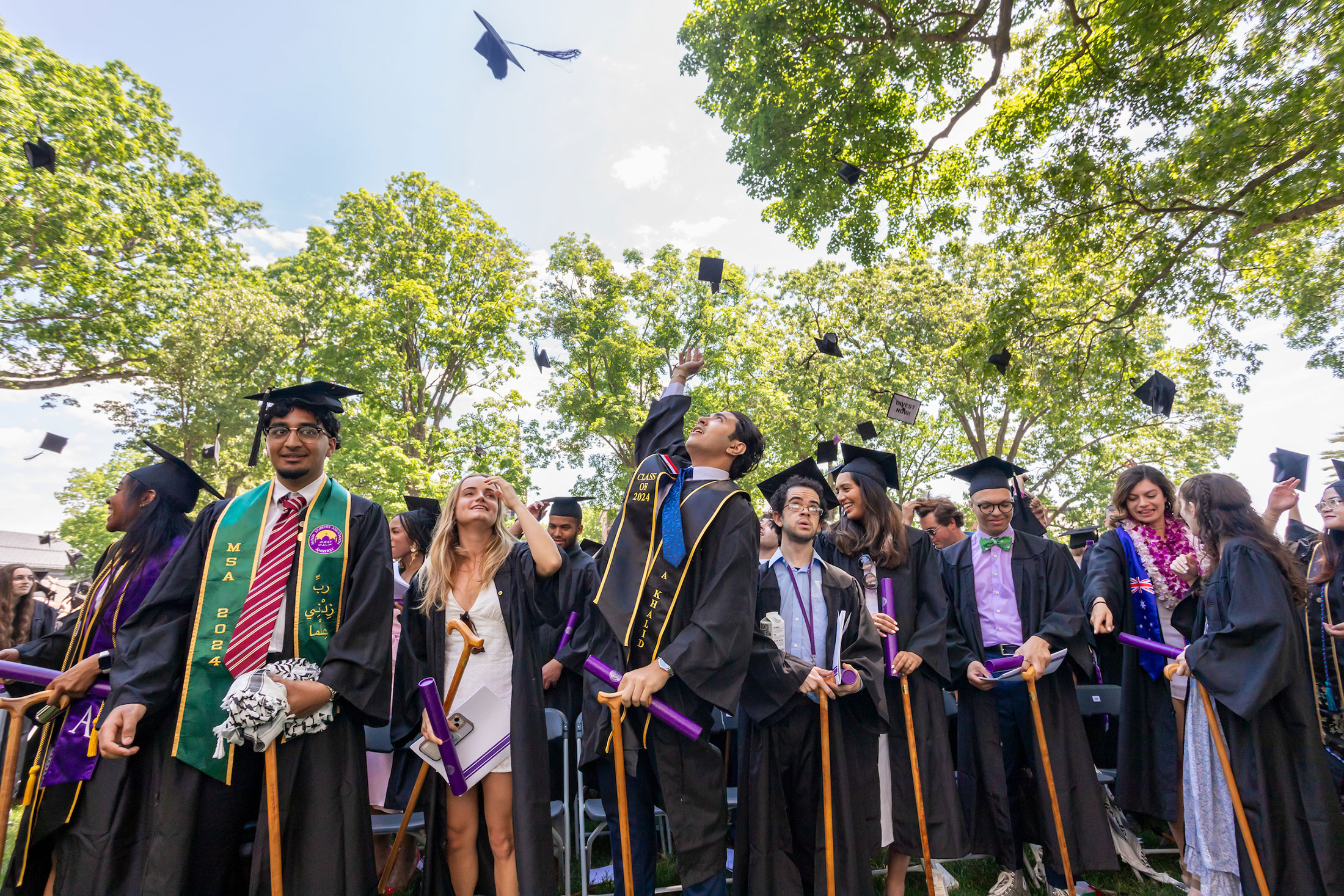 Student toss their graduation caps iat the conclusion of the ceremony.