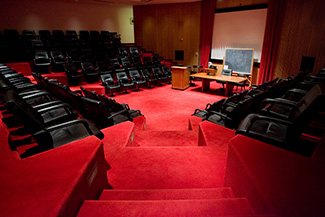 An assembly room with a bright red carpet