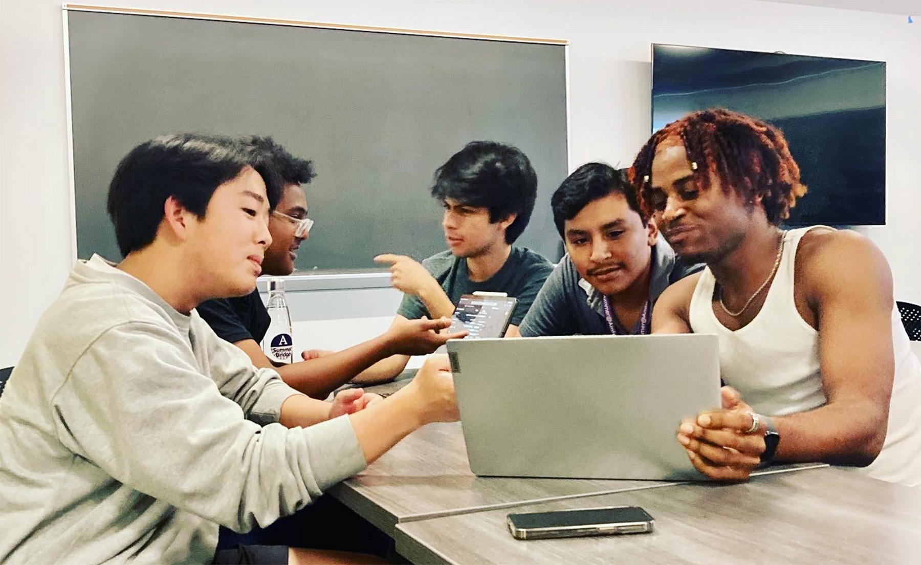 Students in a classroom working on a laptop computer