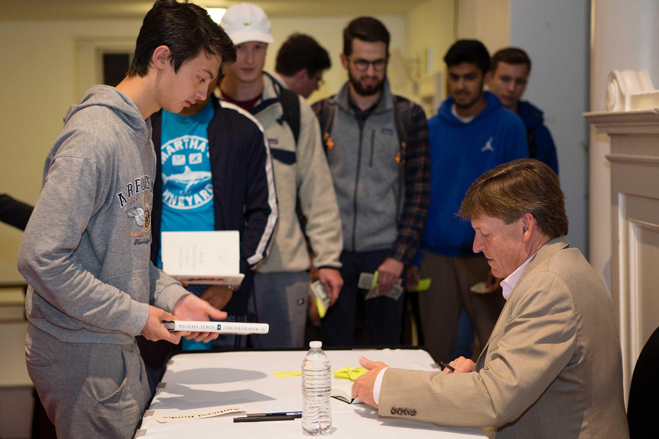 Student wait in line to get copies of Michael Lewis' book signed by the author.