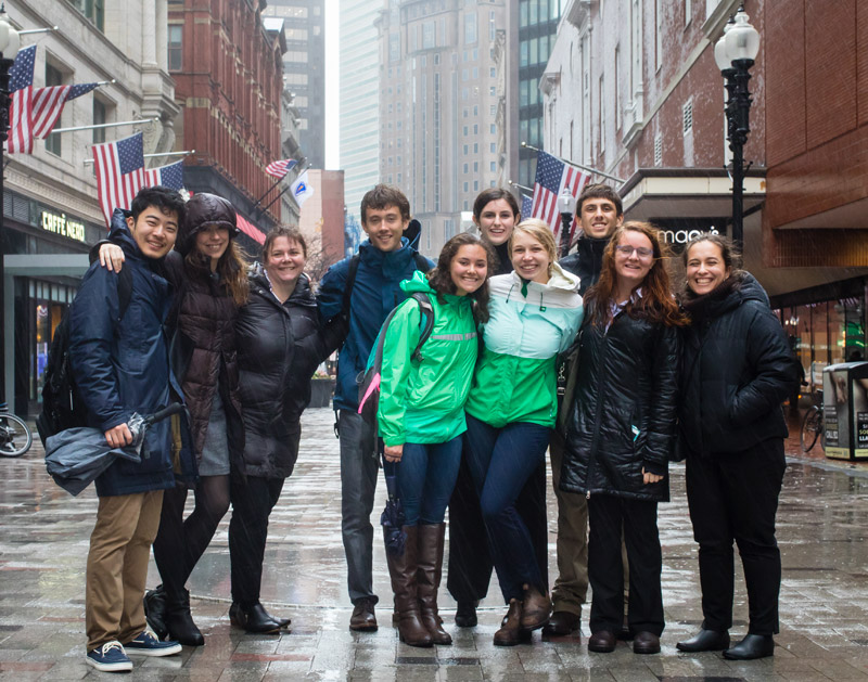 a group of students standing smiling in downtown Boston