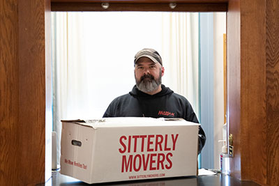 Staff member transporting a box