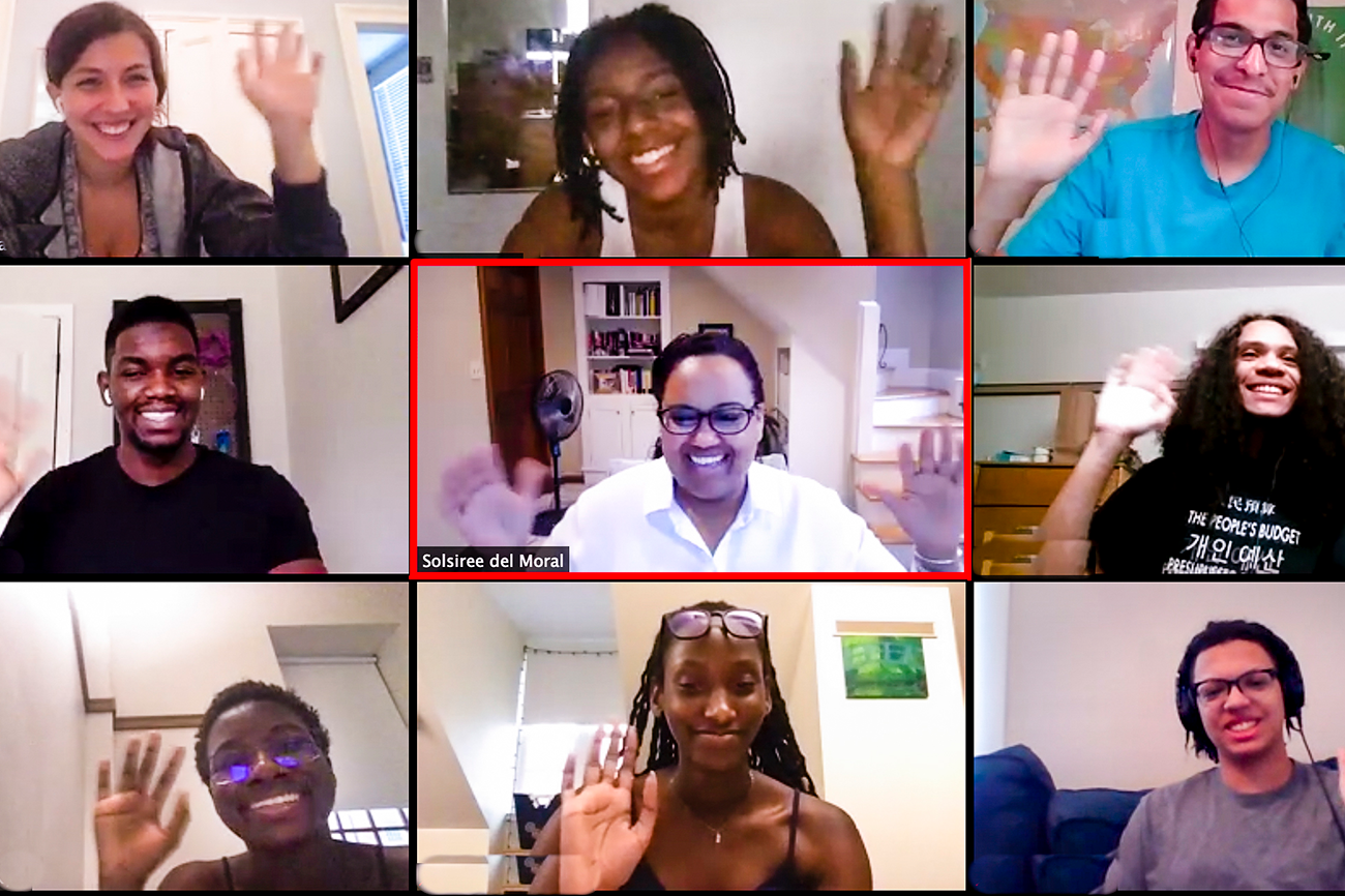 Nine people smiling on a Zoom call