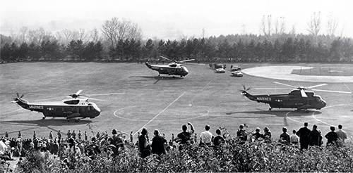 Three helicopters landing on Memorial Field