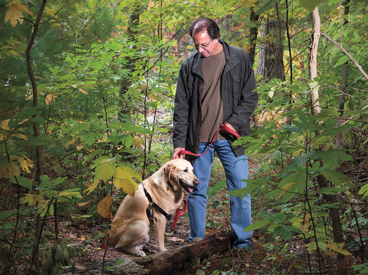 Peter Zheutlin '75 with Albie posing in woods