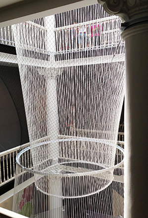 A circular wire-frame sculpture over a interior atrium