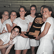 A group of women tennis players holding a trophy