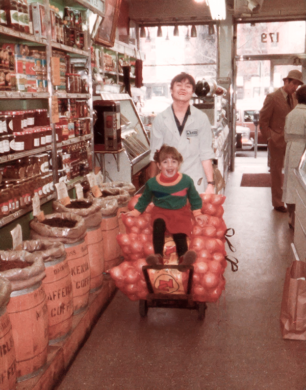 An old photo of a young woman on a cart full of onions